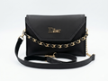 Black handbag with gold chain detail and Dior logo on a white background
